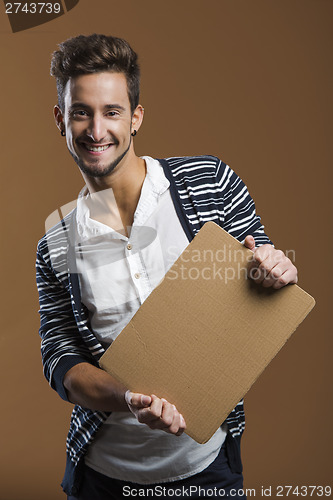 Image of Young man holding a card board