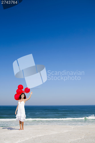 Image of Beautiful girl holding red ballons