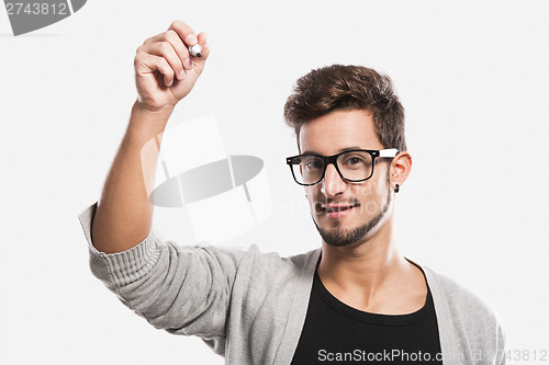 Image of Young man writing on a glass