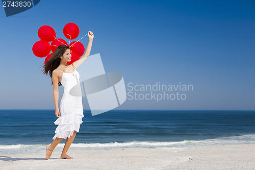 Image of Beautiful girl holding red ballons