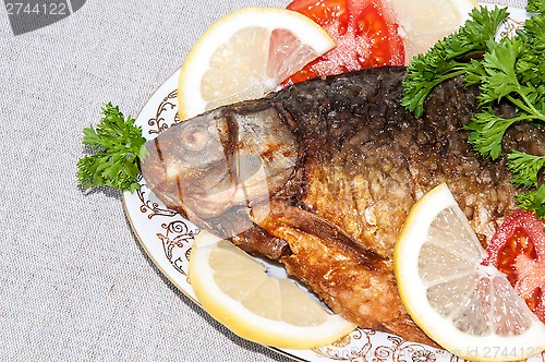 Image of Fresh crucian river fish fried in lemon juice and fresh herbs.