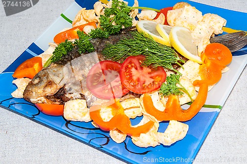 Image of Fresh crucian river fish fried in lemon juice and fresh herbs.