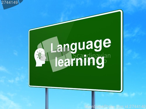 Image of Education concept: Language Learning and Head With Light Bulb on road sign background