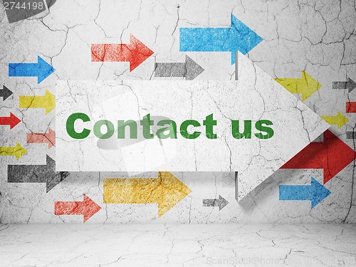 Image of Advertising concept: arrow with Contact Us on grunge wall background