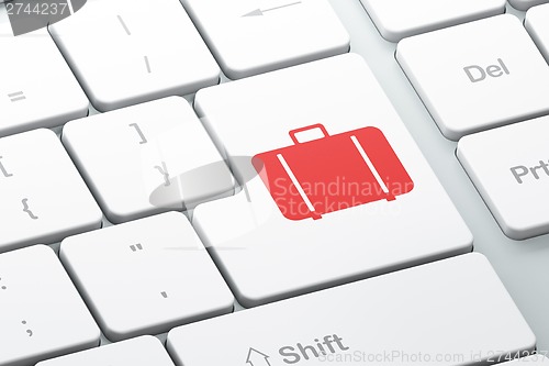 Image of Tourism concept: Bag on computer keyboard background