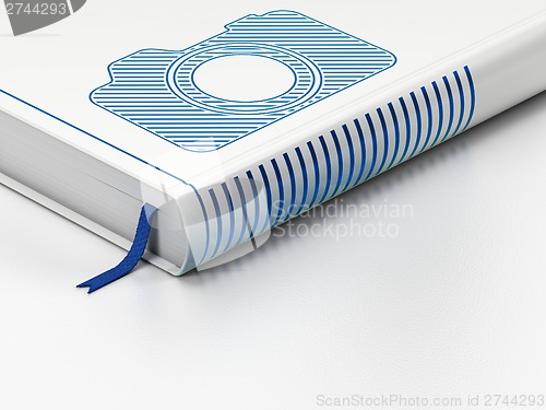 Image of Travel concept: closed book, Photo Camera on white background