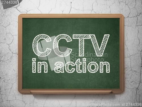 Image of Privacy concept: CCTV In action on chalkboard background