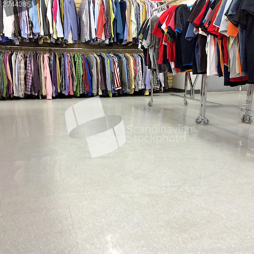 Image of Colorful clothes for sale in a second hand store