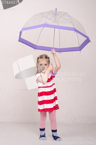 Image of Three year old girl standing with umbrella