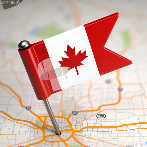 Image of Canada Small Flag on a Map Background.