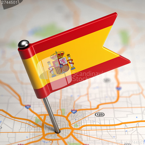 Image of Spain Small Flag on a Map Background.