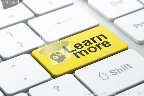 Image of Education concept: Head With Gears and Learn More on computer ke
