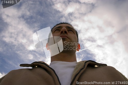 Image of Man Looking up with the Clouds on the Background