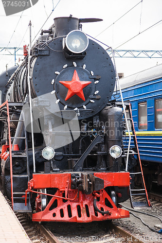 Image of Old steam train is leaving a station