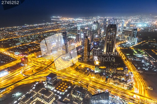 Image of Dubai downtown night scene with city lights,