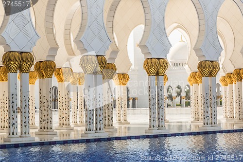 Image of Hallway with golden decorated pillars at the entrance of the wor