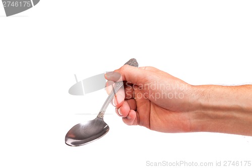 Image of Hand is holding a spoon isolated