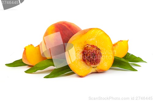Image of Three perfect, ripe peaches with a half  and slices isolated on 