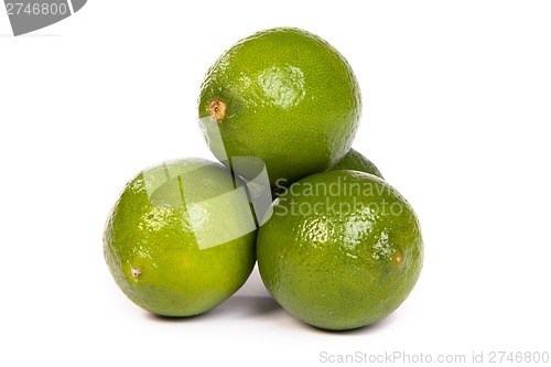 Image of Group of whole limes  and one half lime on white