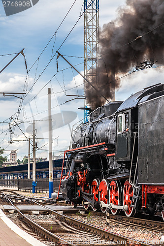 Image of Old steam train is leaving a station