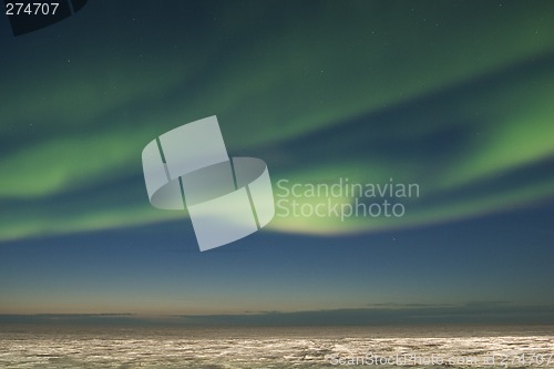 Image of Swirl of aurora over arctic tundra