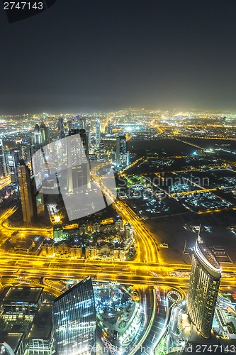 Image of Dubai downtown night scene with city lights,