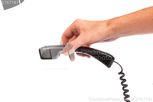 Image of Hand holding an old black telephone tube