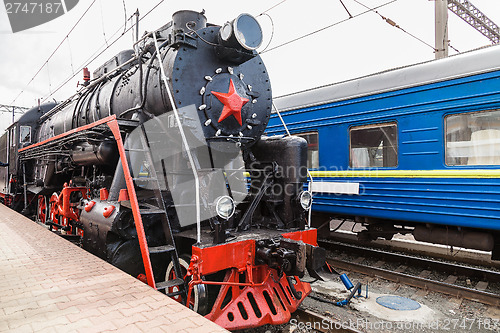 Image of Old steam train is leaving a station