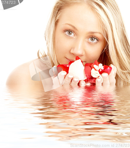 Image of happy blond in water with red and white petals