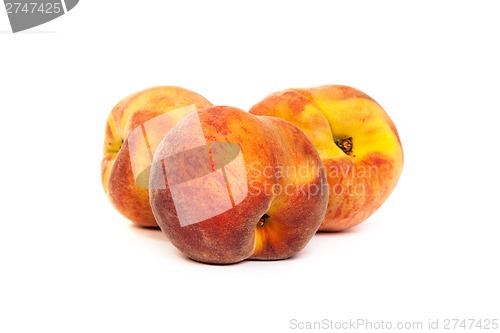 Image of Three tasty juicy peaches on a white background