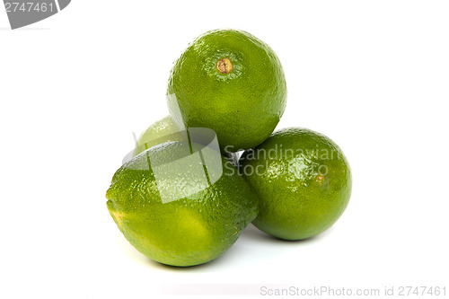 Image of Group of whole limes  and one half lime on white