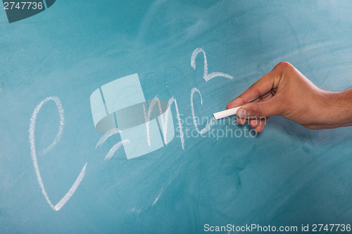 Image of Einstein's Formula E=mc2 on a blackboard