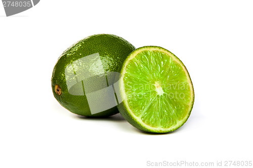 Image of One whole lime and one half lime on white