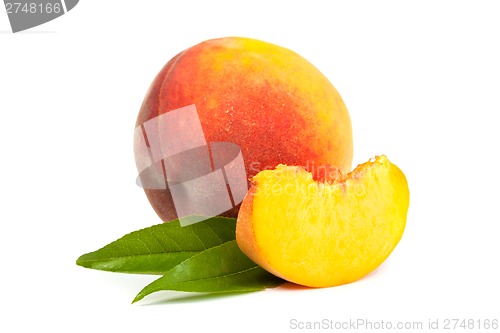 Image of One perfect, ripe peache with slices isolated on a white backgro