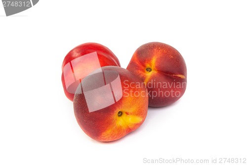 Image of Three fresh nectarines on white