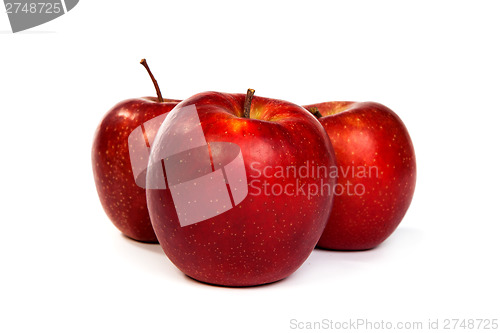 Image of Three shiny red apples isolated on white