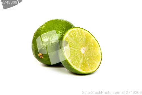 Image of One whole lime and one half lime on white