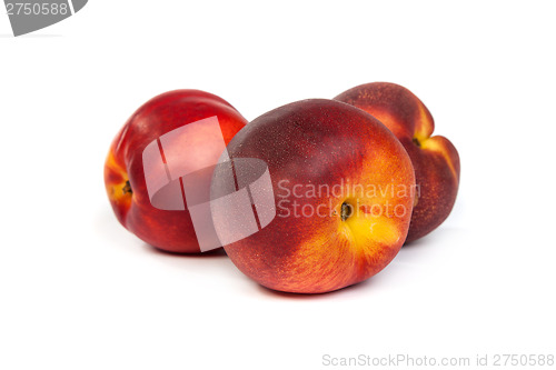 Image of Three fresh nectarines on white