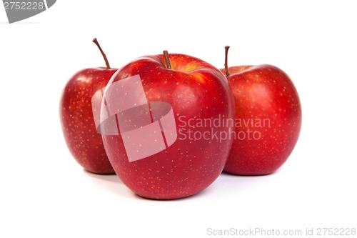 Image of Three shiny red apples isolated on white