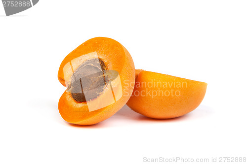 Image of Two ripe apricot sectioned by knife