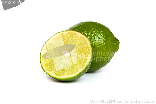 Image of One whole lime and one half lime on white