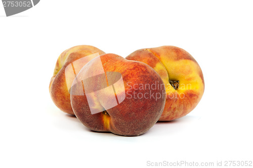 Image of Three tasty juicy peaches on a white background