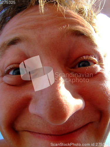 Image of The person of a smiling young man. A funny picture