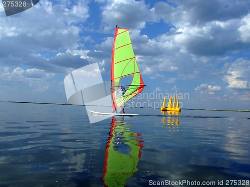 Image of Windsurfer and its reflection in water of a gulf