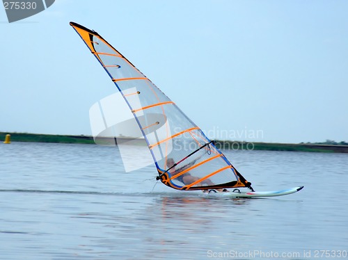 Image of windsurfer on waves of a gulf in the afternoon