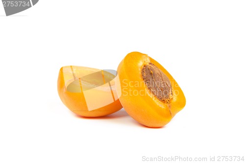 Image of Two ripe apricot sectioned by knife