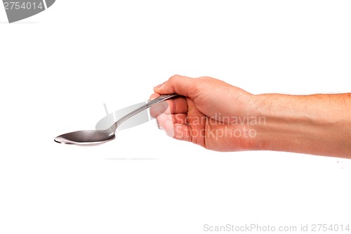 Image of Hand is holding a spoon isolated