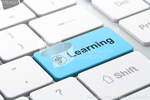 Image of Education concept: Head With Gears and Learning on computer keyb