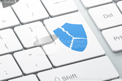 Image of Security concept: Broken Shield on computer keyboard background