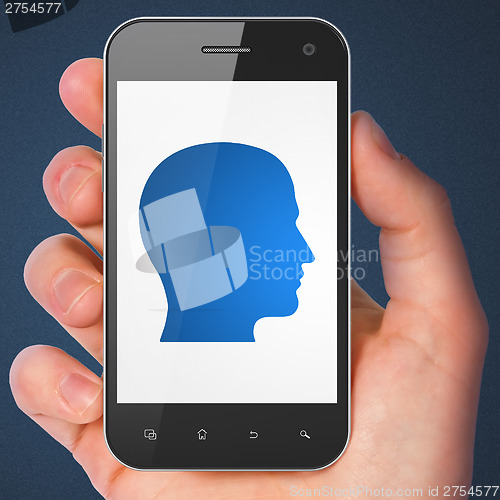 Image of Finance concept: Head on smartphone